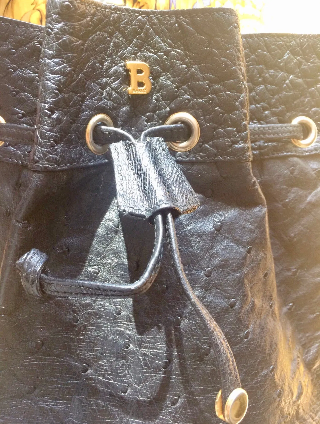 80's vintage BALLY genuine black ostrich leather hobo bucket shoulder bag with golden B logo and drawstrings.