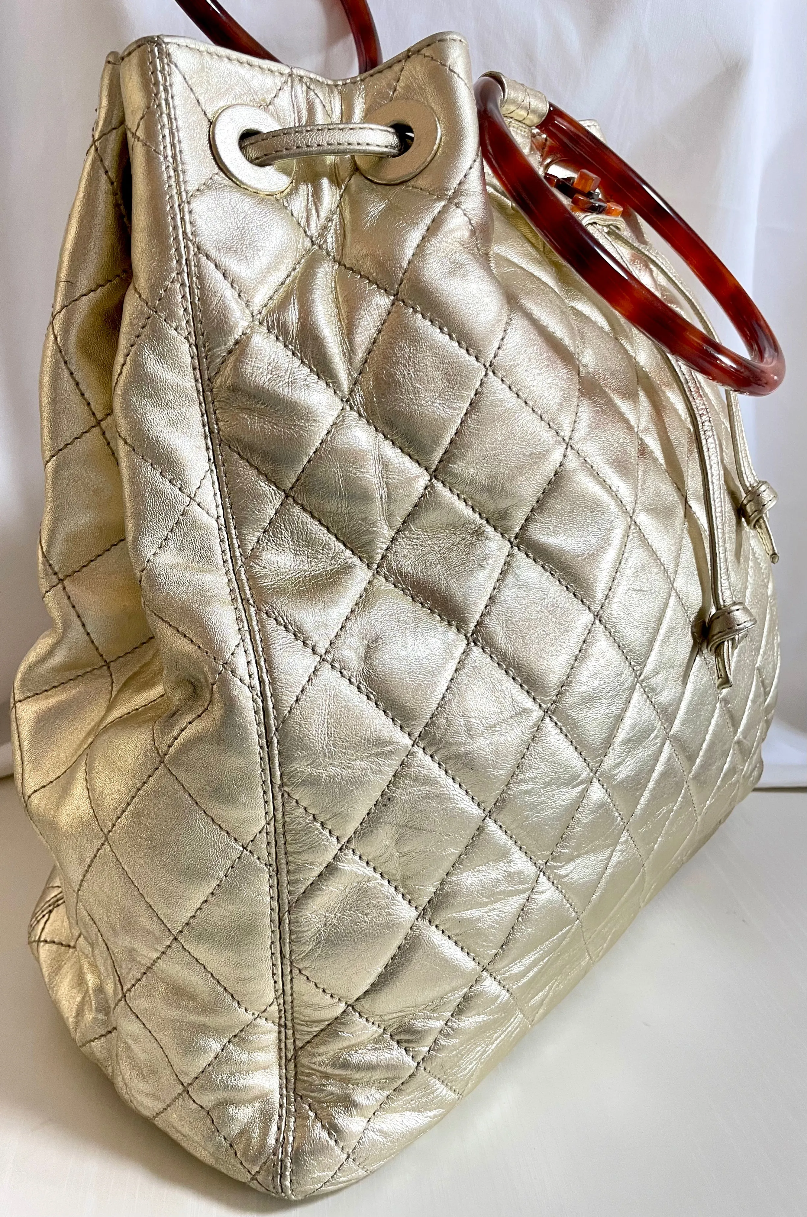 Vintage CHANEL campaign gold lamb leather hobo bucket bag with marble hoop handles and turn lock CC. 0412081