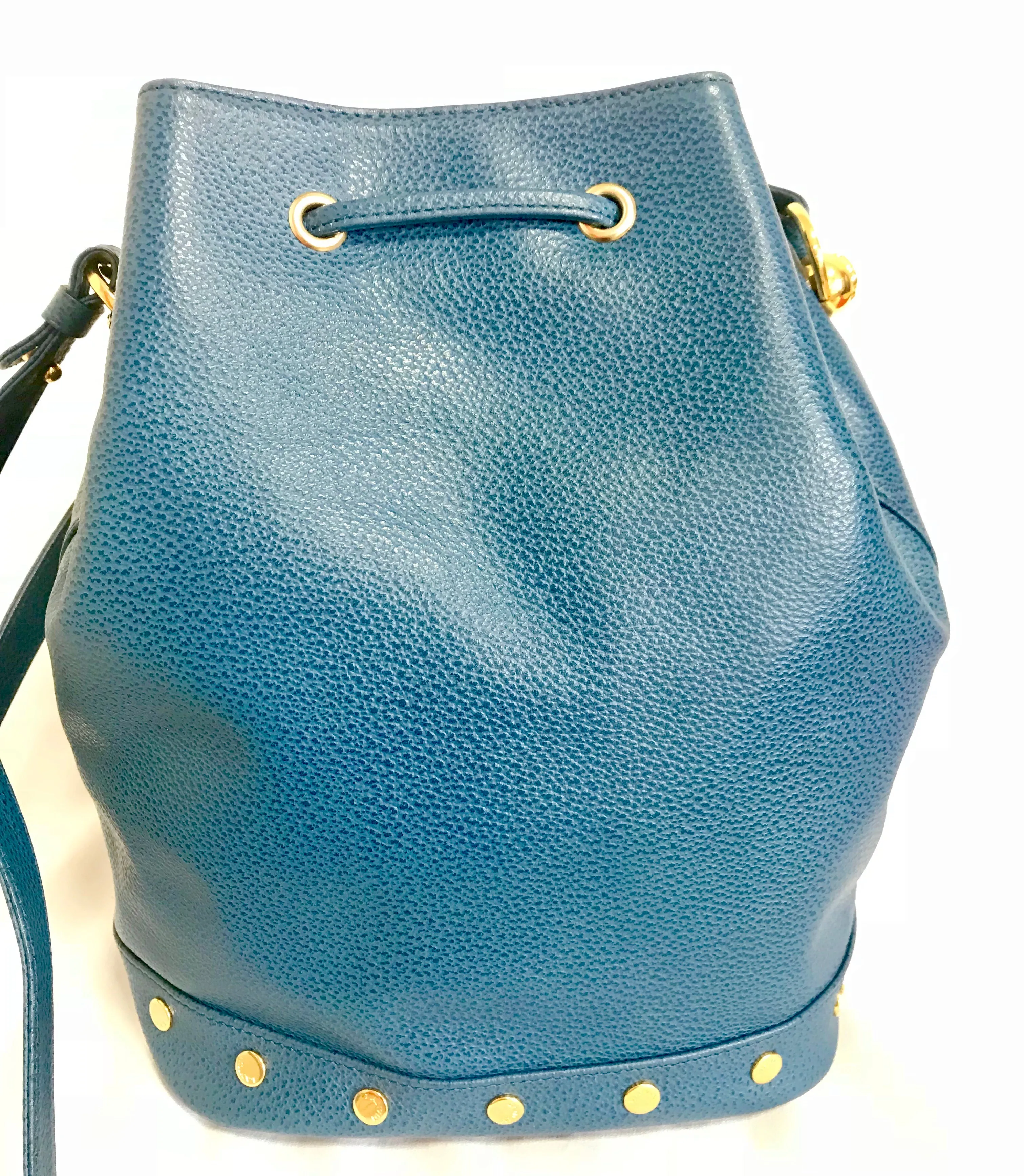 Vintage LANVIN blue grained leather hobo bucket shoulder bag with golden logo motifs.